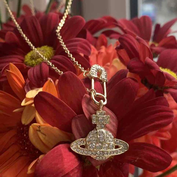 Brand new Saturn Orb necklace in gold